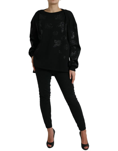 Elegante suéter negro con apliques florales