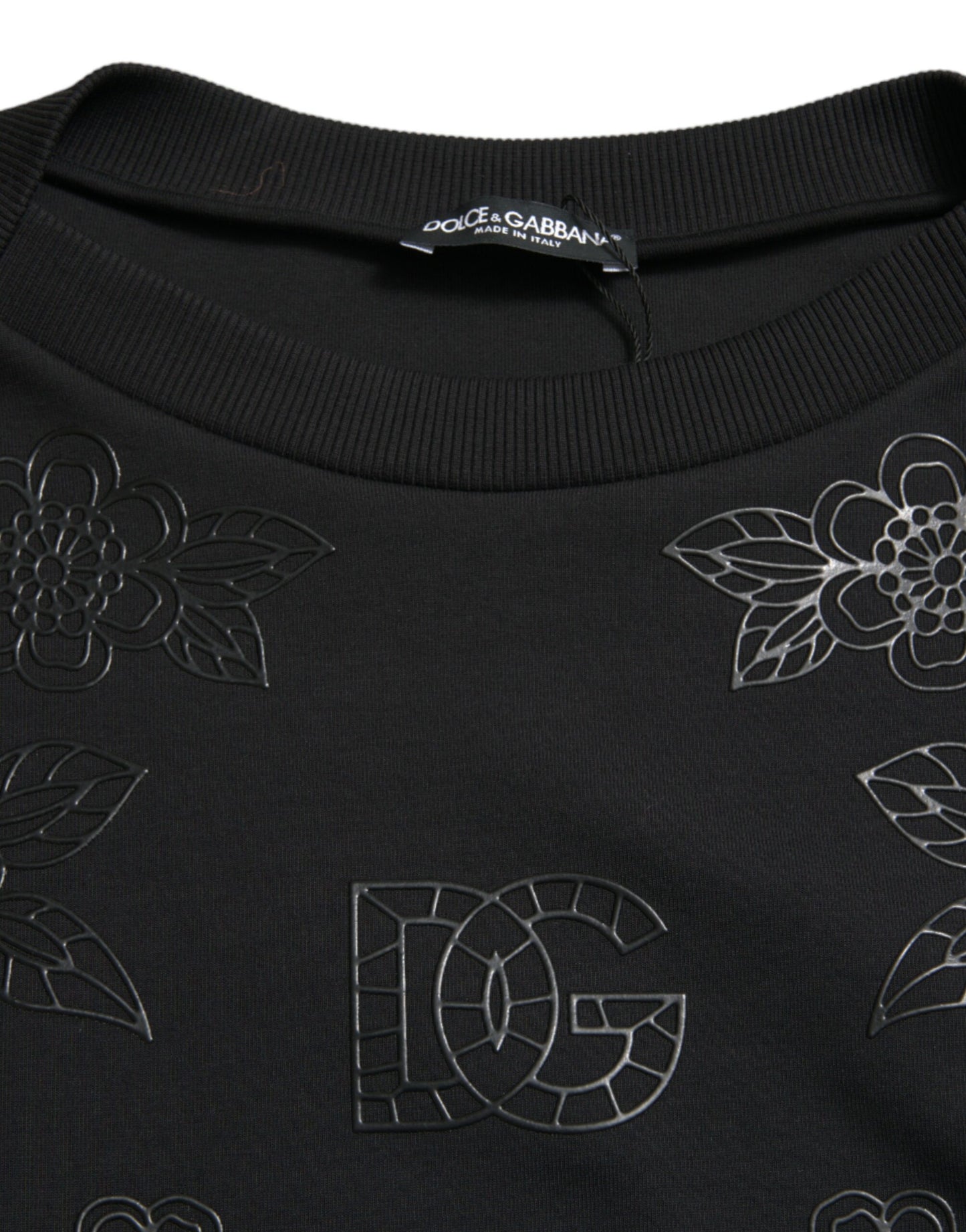 Elegante suéter negro con apliques florales