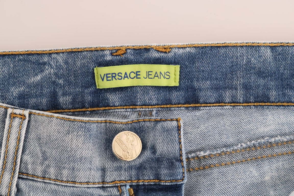 Vaqueros ajustados rasgados y elegantes de color azul claro