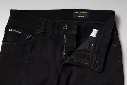 Vaqueros ajustados de algodón negro con logo y rotos